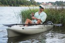 a fisherman fishing from a kayak